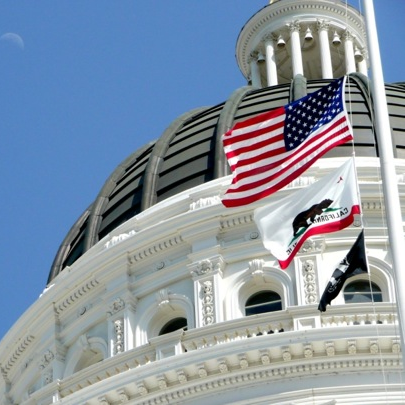 CA capitol dome with flags